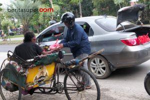 Ketua Komunitas Jaguar69, saat membagikan takjil kepada tukang becak.